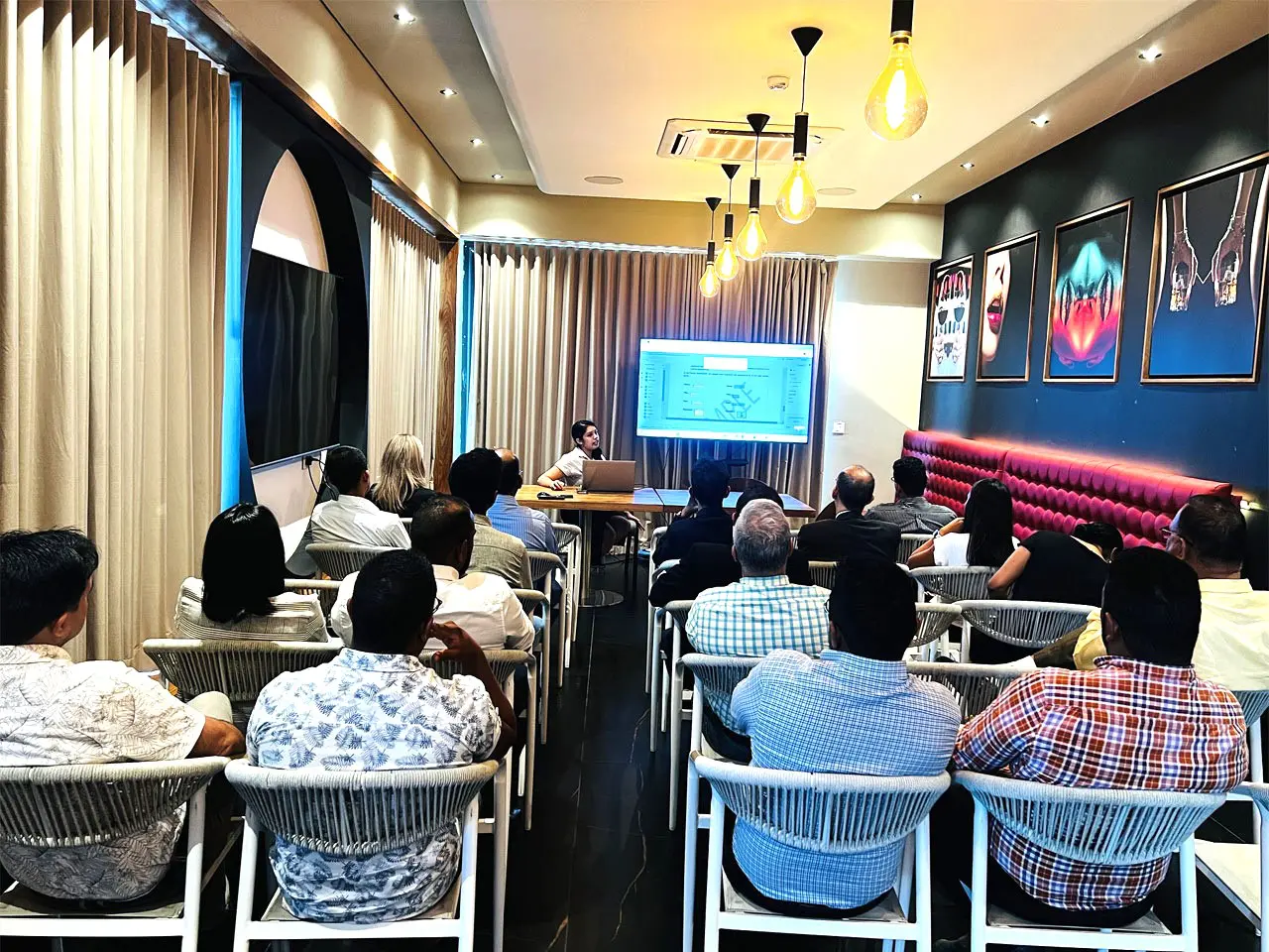 People attending a presentation in a meeting room.
