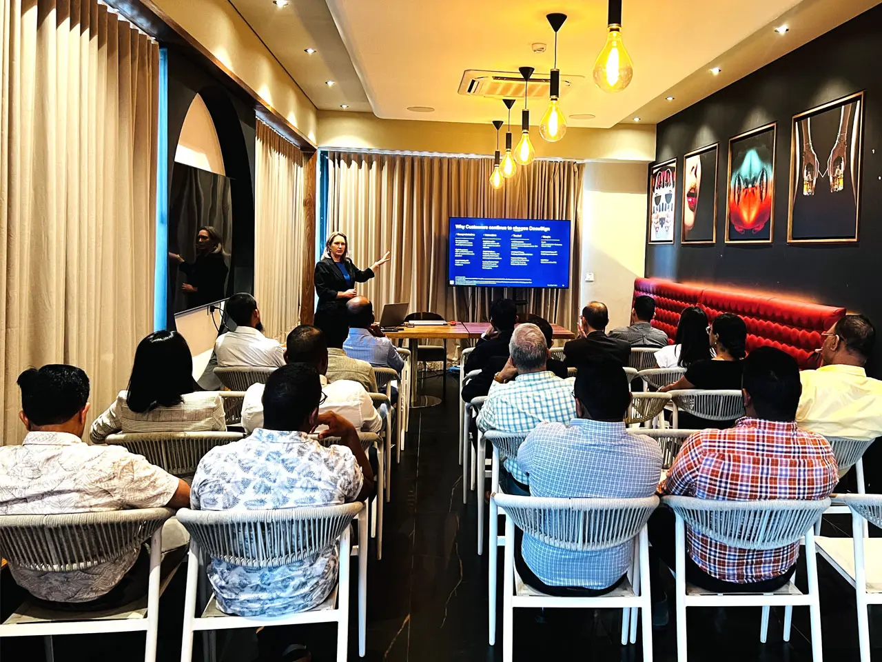 People attending a presentation in a room.