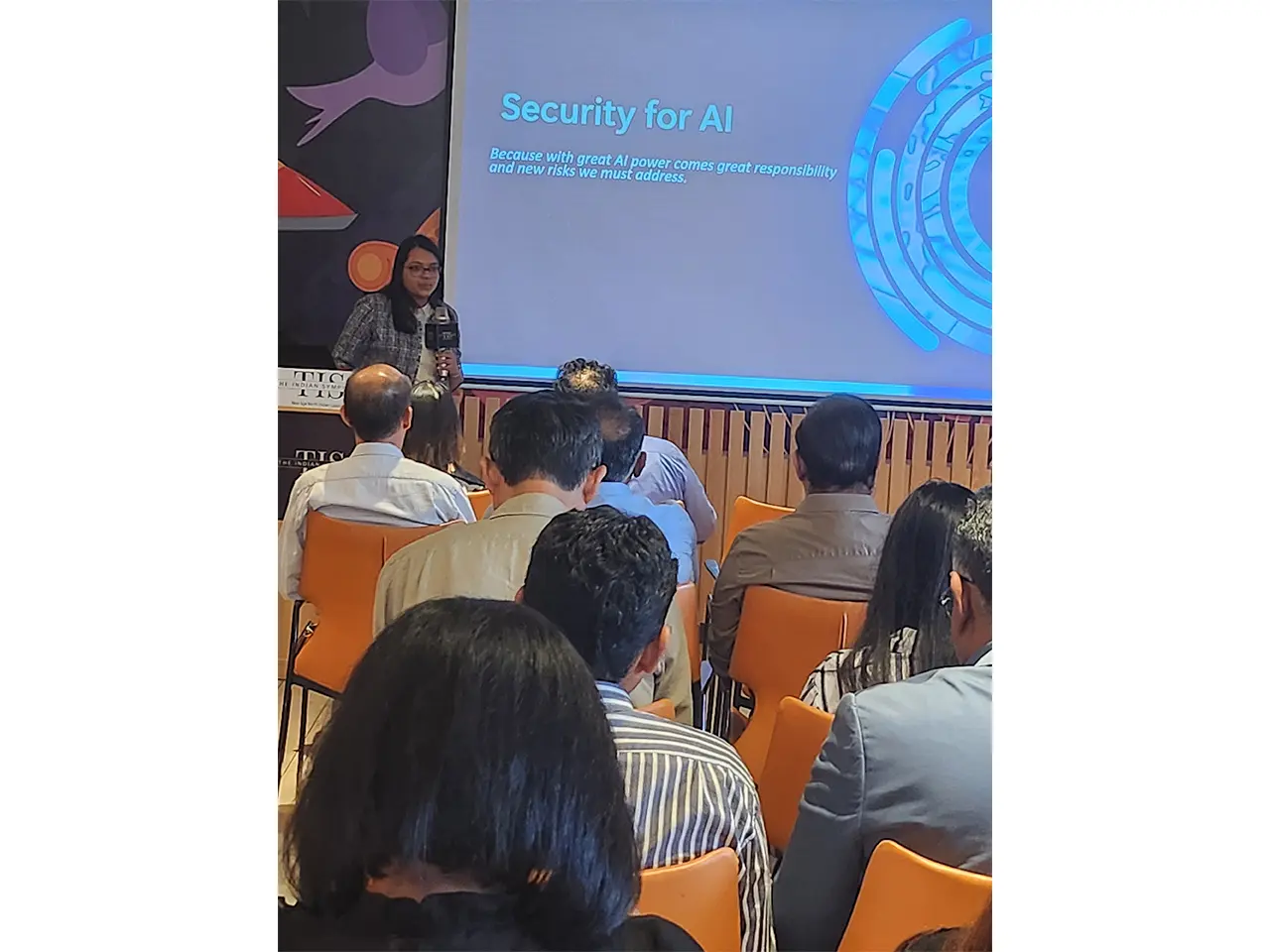Audience listening to AI security presentation.