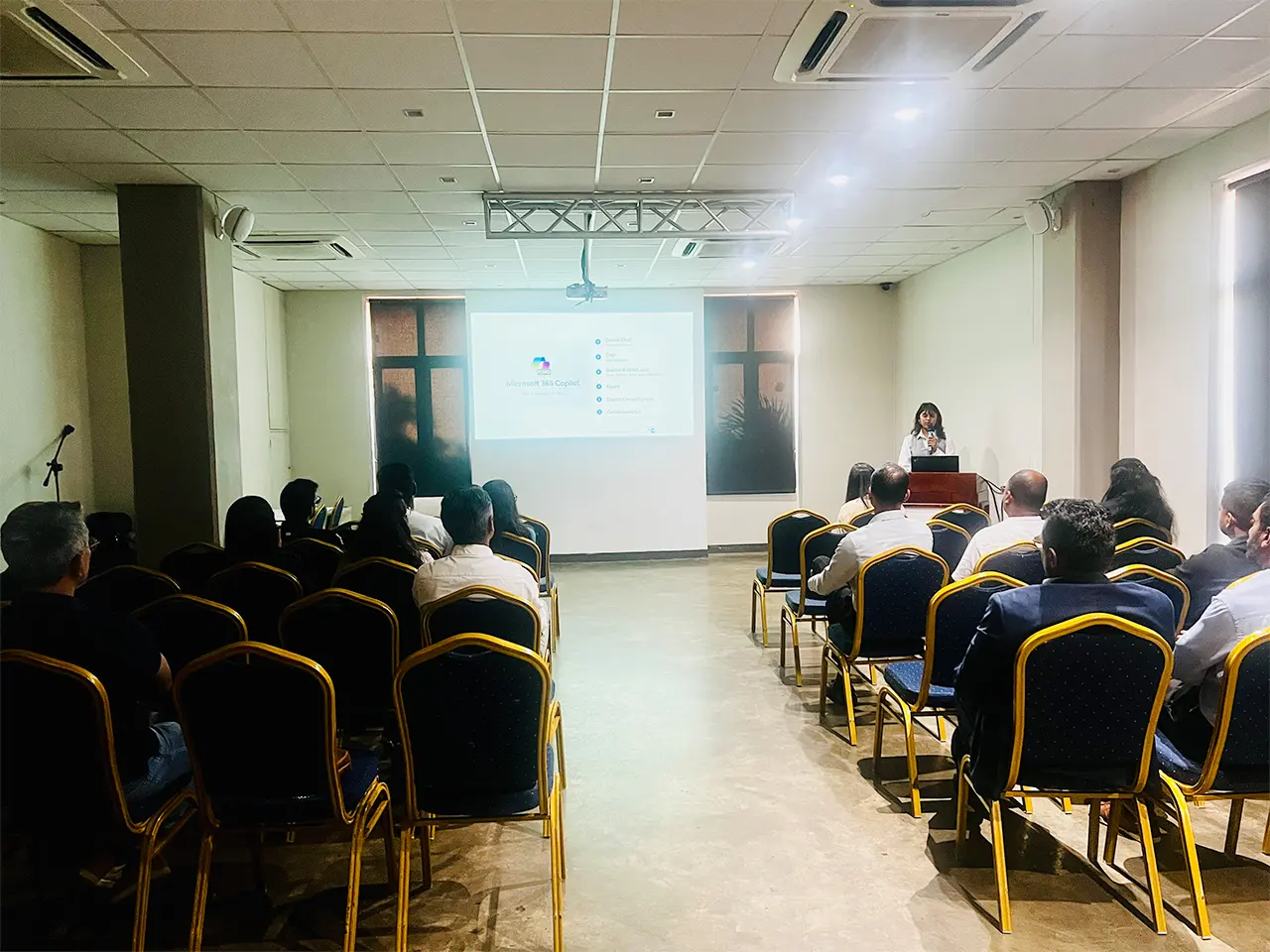 Presentation in a conference room with attendees.