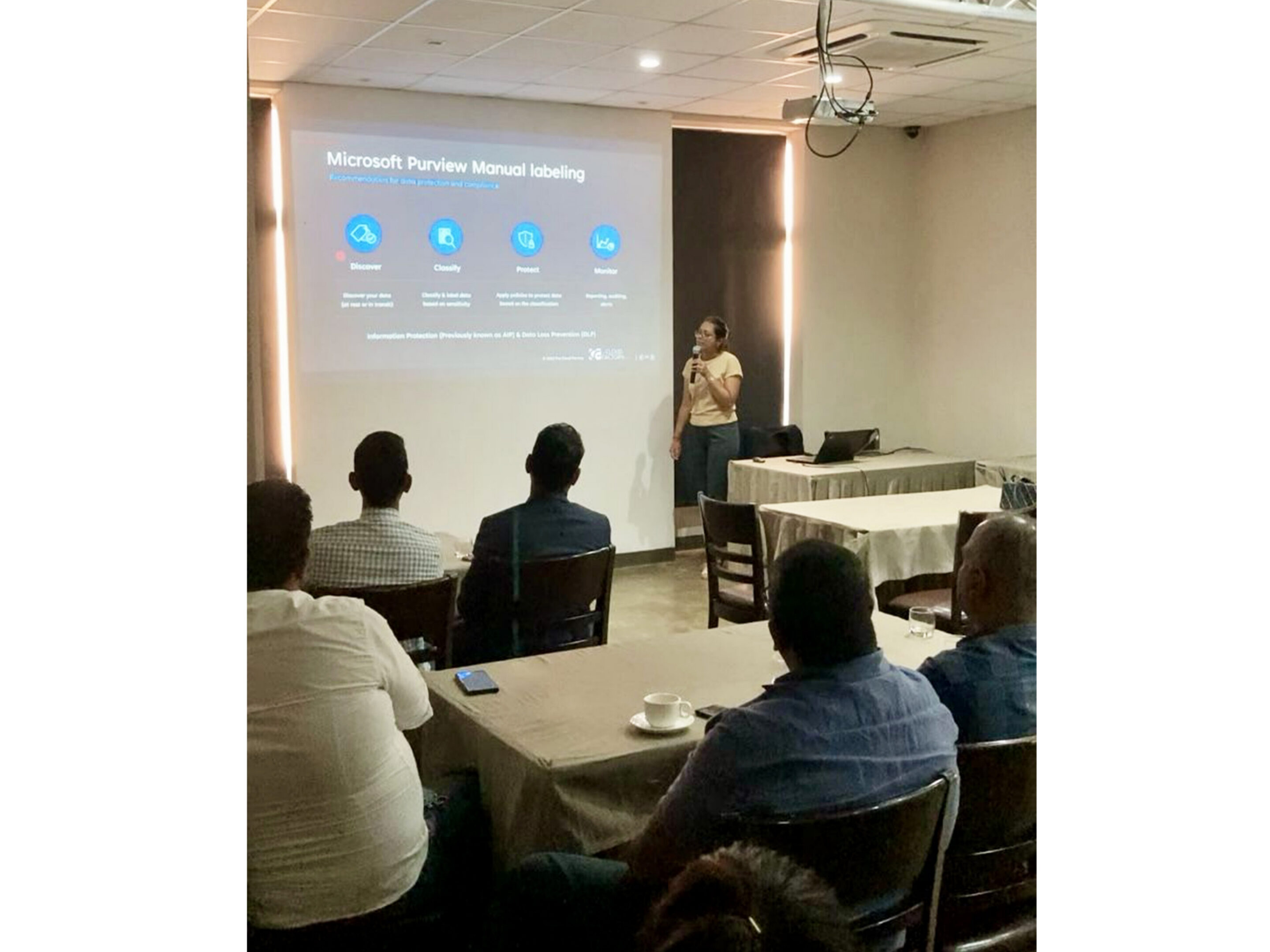 Person presenting to group in a conference.