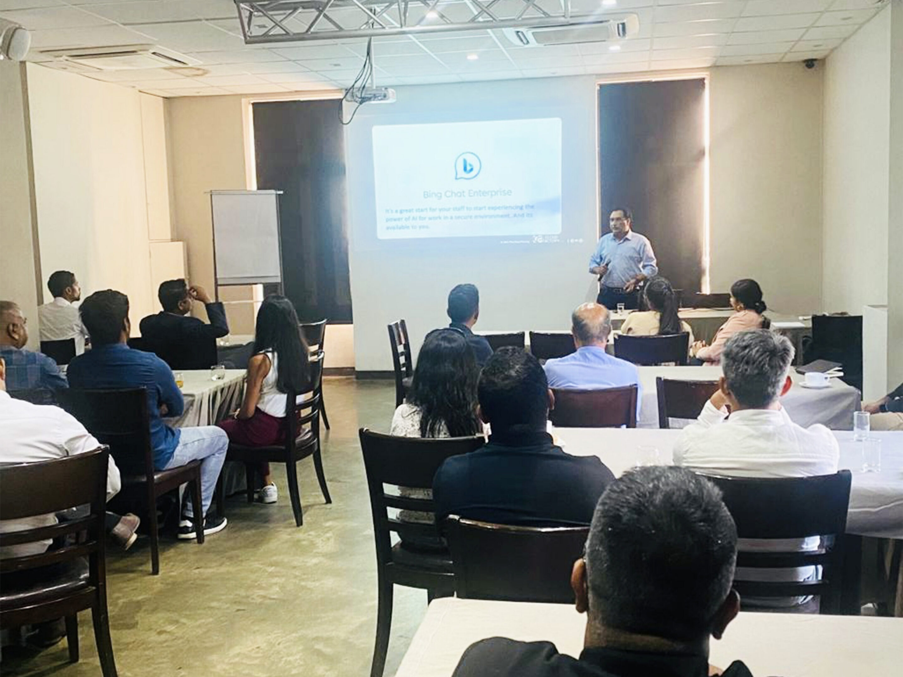 Presentation in a conference room with attendees.