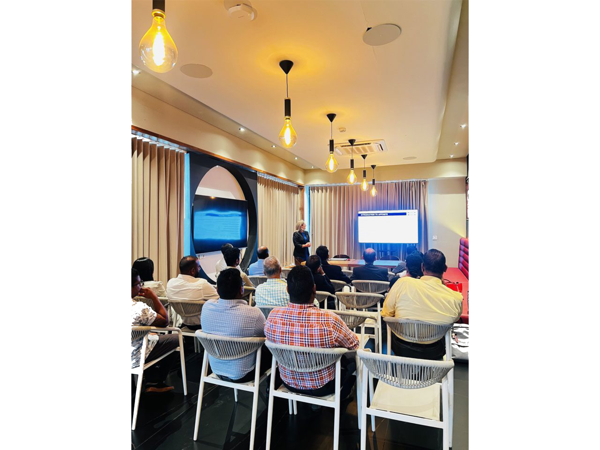 People attending a presentation in a room.