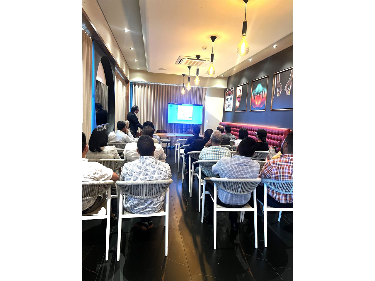 People attending a presentation in a room.