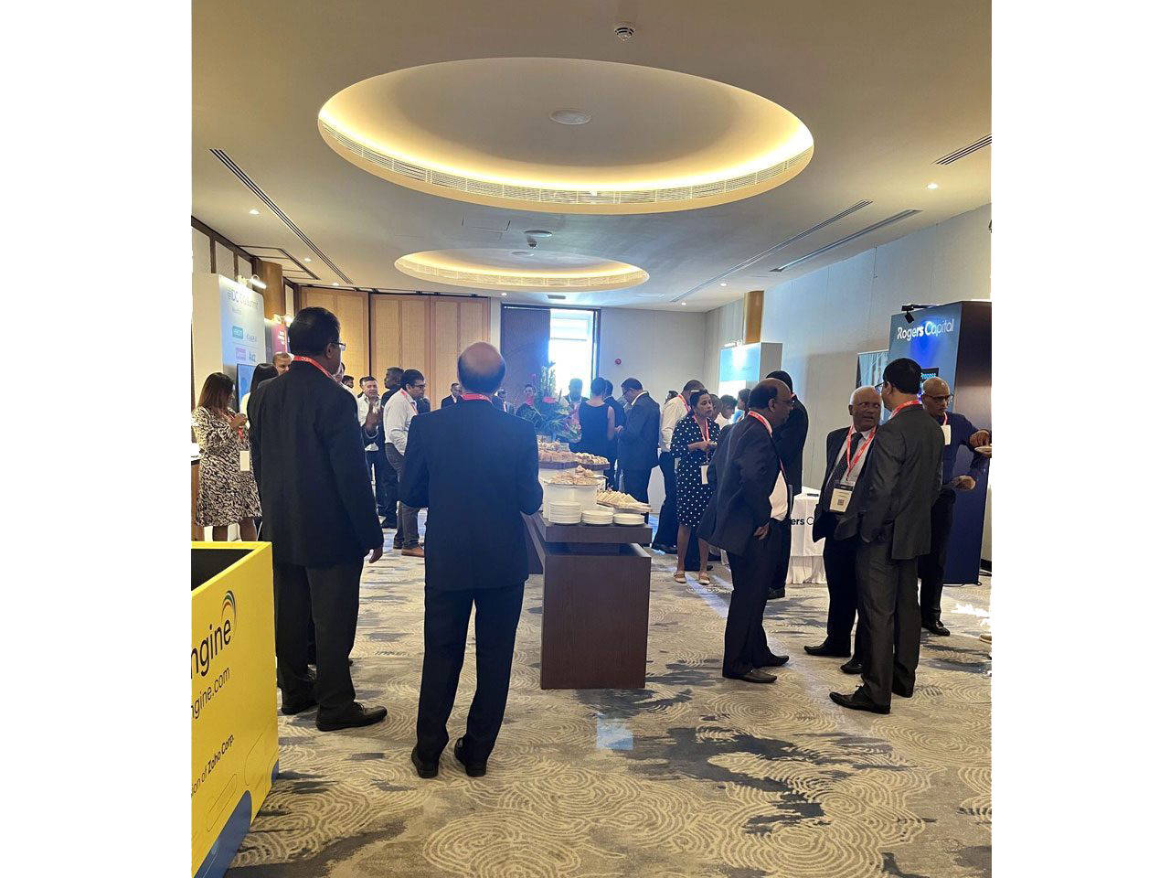 Conference attendees networking in a meeting room.