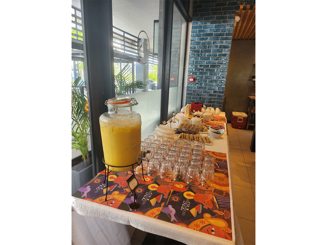 Buffet table with juice and glasses.