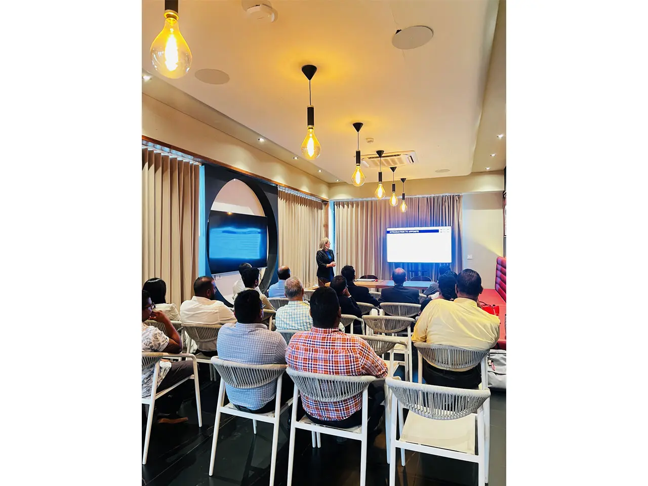 Presentation on business strategy in a modern conference room with attendees.