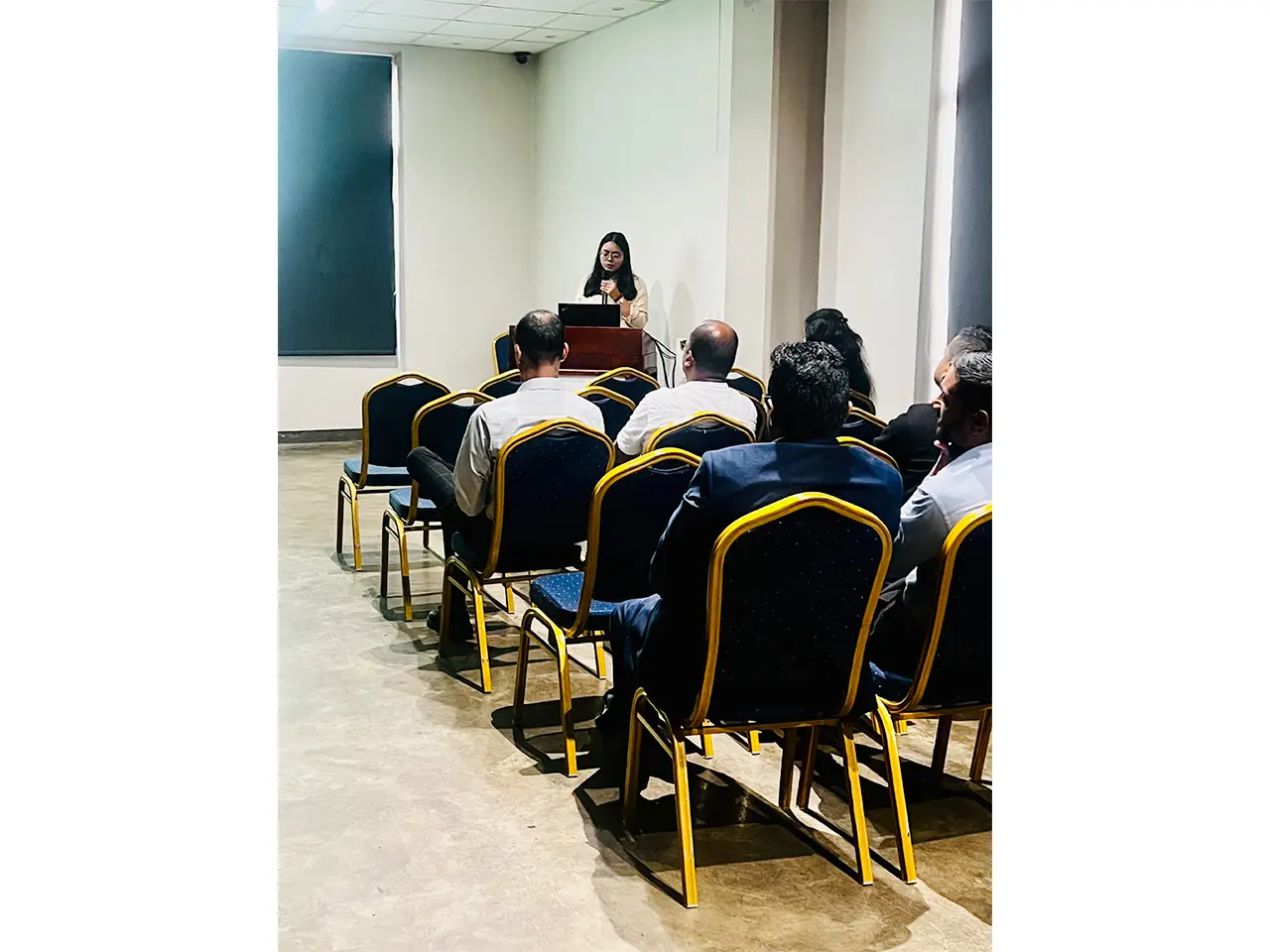 Woman presenting to audience in conference room